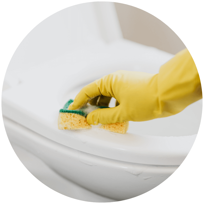 a person cleaning a toilet rim