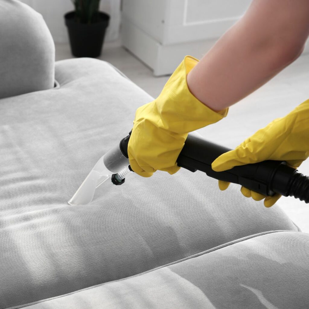 a person washing a couch